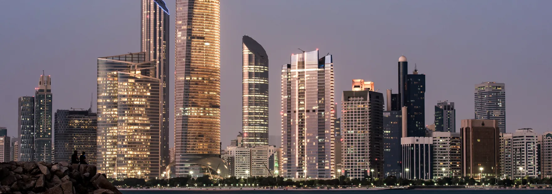 The Abu Dhabi city skyline at dusk, the area served by Oasis Flow water delivery